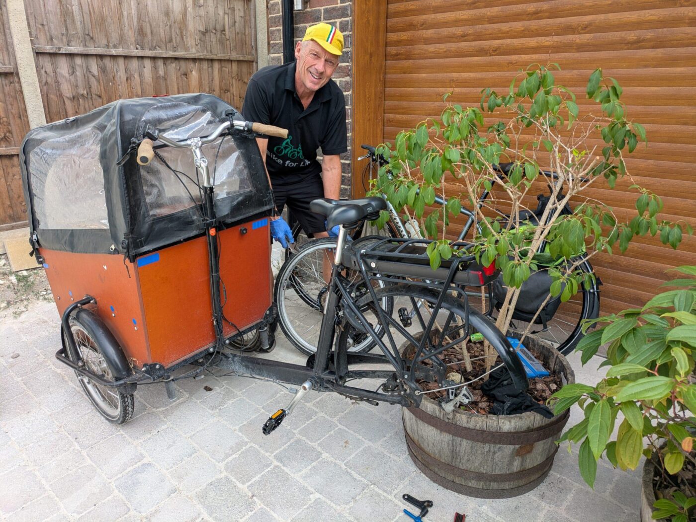 Getafix Cycles mechanic servicing an electric cargo bike at a customer’s home in Brighton